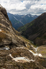 View over rocky path and slopes of mountain ranges in Tien-Shan, Kyrgyzstan