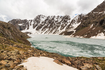 Panoramic view over the frozen lake Ala-Kul from the slope. Tien Shan. Kyrgyzstan