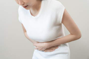 Flatulence asian young woman intolerance hand in stomach ache, suffer from food poisoning,...