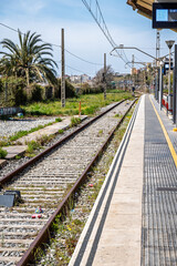 Fototapeta premium Empty Railway Platform with Cityscape View