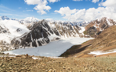 Aerial panoramic view over the frozen  lake Ala-Kul from mountain pass. Tien Shan. Kyrgyzstan