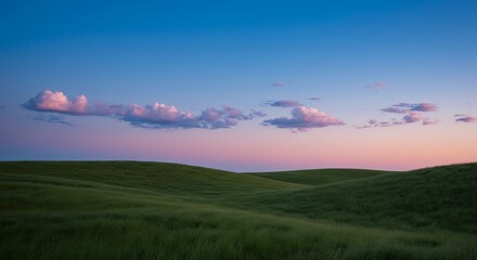 Obraz premium Scenic Landscape of Green Hills Under a Colorful Sky