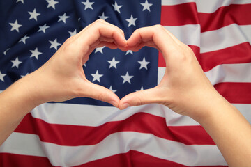 Independence day USA and memorial day or 4th of July. Hands showing heart and love against LGBT flag