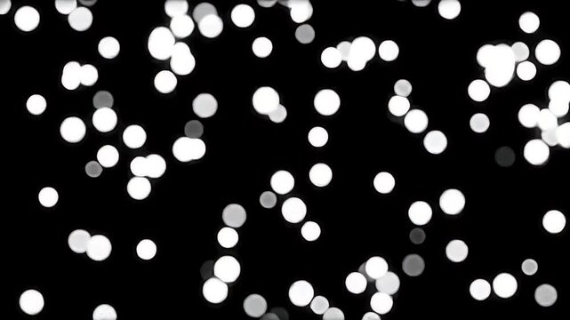 A seamless loop animation of soft white snow dots gently falling against a pitch-black background.