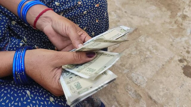 Indian female counting 500 rupees Indian currency notes