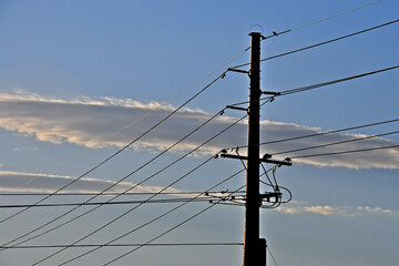 Tapping off main electrical transmission lines to service other areas. Bird perches on ground wire...