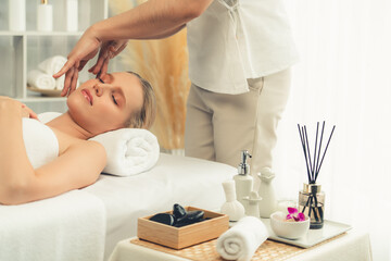 Caucasian woman enjoying relaxing anti-stress head massage and pampering facial beauty skin...