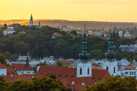 Golden sunset lights up St. Norbert Church and Assumption of the Virgin Mary, creating serenity