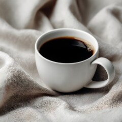 A cup of hot black coffee on a beige linen cloth