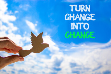 Turn change into chance symbol. Concept words phrase Turn change into chance on beautiful sky. Businessman's hand. Beautiful blue sky background. Business Turn change into chance concept. Copy space.