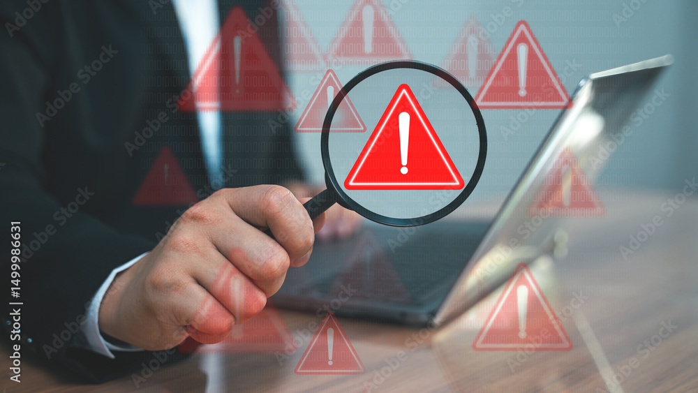 Poster a businessman pointing at a red warning symbol on a digital screen. cybersecurity alert or system er