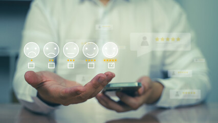 A man interacting with virtual rating and feedback icons through a smart device. Customer...