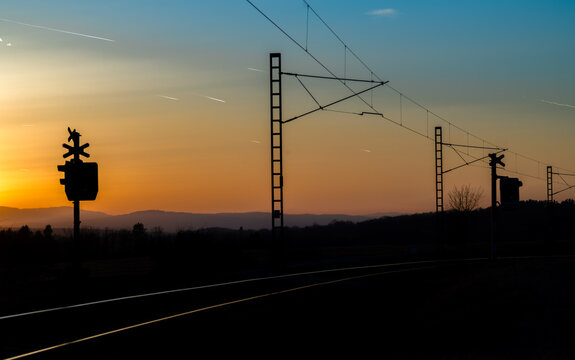 Railway crossing with red lights with sunset evening near Trocnov village