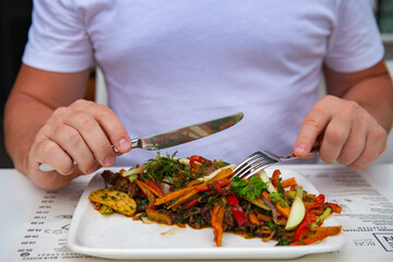 One man dines on different vegetables in a restaurant