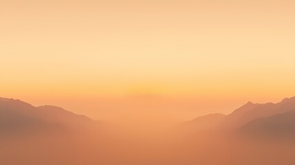 Fototapeta premium Serene sunrise over misty mountains. Peaceful landscape, nature, tranquility, calm, dawn, golden hour.