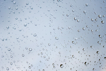 grey moody raindrops on a window glass