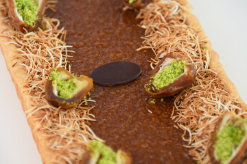 Pistachio and Date Tart garnished with halves of dates filled with vibrant green chopped pistachios...