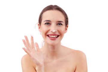 Happy young woman smiling while applying skincare moisturizer cream, showing beauty cream on her finger and on tip of nose. Isolated on a background. Facial treatment, makeup and healthy skin