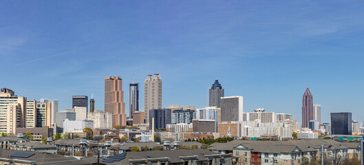 Downtown Atlanta Skyline showing several prominent buildings hotels under a blue sky.