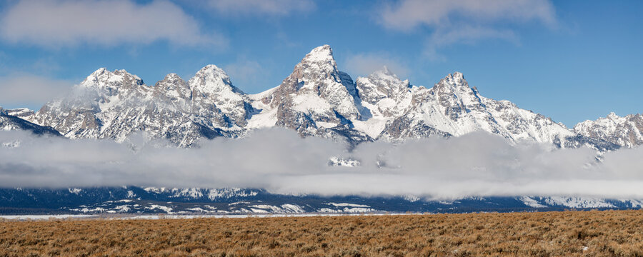 USA, Wyoming, Jackson. Grand Teton National Park, Panoramic view of fog hovering beneath the Teton Range