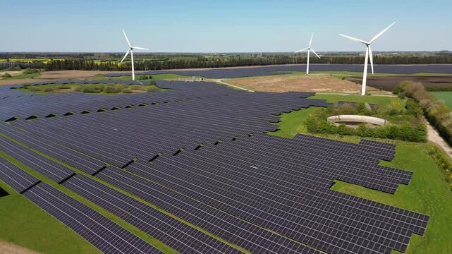 Drone view of Denmark&rsquo;s largest solar farm in Kass&oslash; with wind turbines and green energy