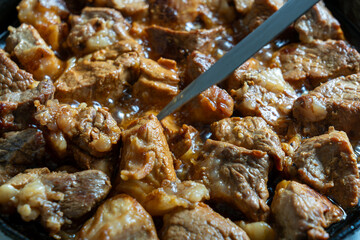 Savory beef stew simmering in rich sauce on a stovetop