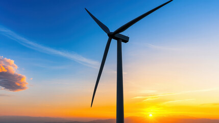 Obraz premium A wind turbine captures the last rays of sunshine as the sky transforms into a canvas of brilliant colors. The serene landscape emphasizes the importance of renewable energy sources