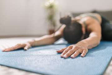 Obraz premium Practicing yoga indoors with focus on stretching in a serene environment