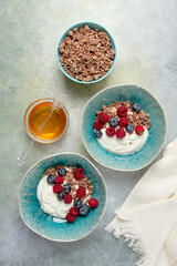 Breakfast, two bowls, yogurt, muesli with berries, and honey, homemade, no people,