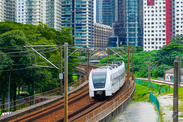 Obraz premium High-speed metro train travels across a city skyline express suburban metro train to the airport departs at the turn