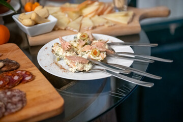 Traditional wooden board with assorted Italian cured meats and salami ready to serve