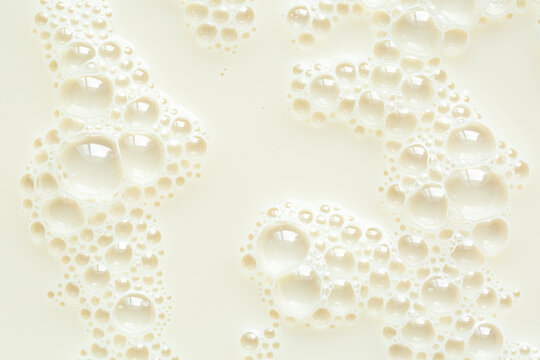 Macro milk surface close-up,Macro milk texture,White surface of milk and bubbles and ripples from above birds eye view