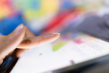 Fingers poking the tablet screen macro,Extreme close up of female finger using digital tablet...