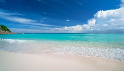 Fototapeta premium a serene beach with clear turquoise water gently meeting the sandy shore under a blue sky with clouds