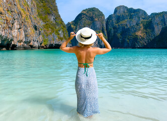 Woman enjoying scenic maya bay in Thailand's crystal clear waters, amazing travel photo