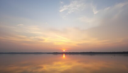 Naklejka premium Tranquil Sunset Over Still Water with Colorful Sky Reflections