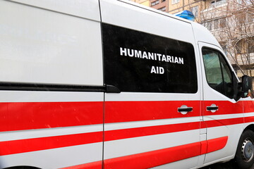 Naklejka premium Bus with sign Humanitarian aid stands near destroyed house after being bombed by Russian missiles, Dnipro, 2025.