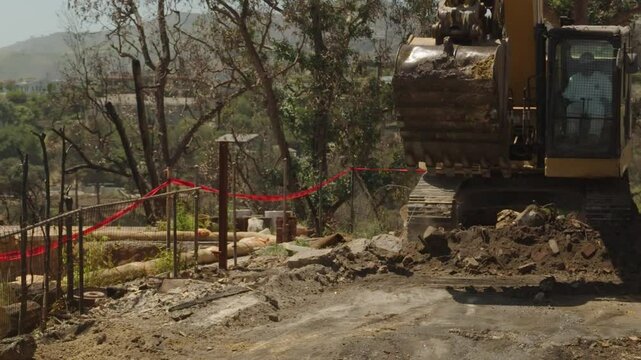Excavator at work in fire debris removal