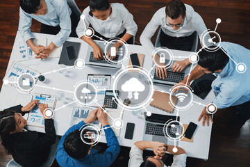 A dynamic group of professionals collaborates on a computing project, utilizing cloud technology...