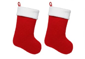 Two red christmas stockings with white fur cuffs isolated on white background