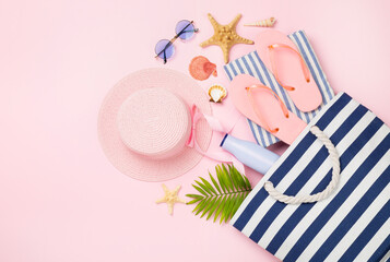 Blue beach bag with summer accessories on color background, top view