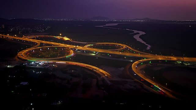 India's longest sea bridge: Trans-Harbour Sea Link. Atal Setu sea bridge in Mumbai, Maharashtra, India. Time-lapse of a city at night with bright skyscrapers and a dense network of glowing buildings.