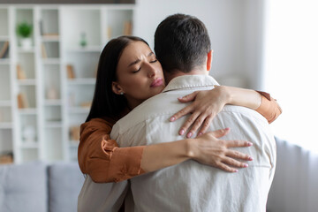 Family support. Woman embracing husband for comfort, grief and care after bad news or problems,...