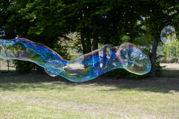 Large soap bubbles floating in the air – colorful playful scene