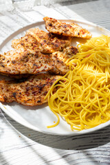 Close-up of fried chicken and spaghetti pasta Italian style restaurant presentation