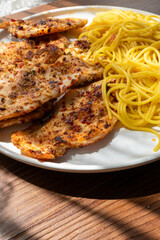 Close-up of fried chicken and spaghetti pasta Italian style restaurant presentation
