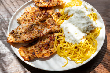 Close-up of fried chicken and spaghetti pasta Italian style restaurant presentation