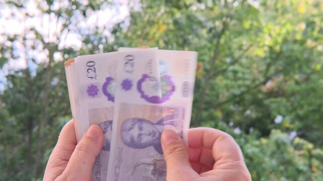 Close-up female hands counting uk pounds bills, paper money on blurred background, British GBP banknotes, Money Management Accuracy, salary, payments to fund, financial freedom, save up for vacation