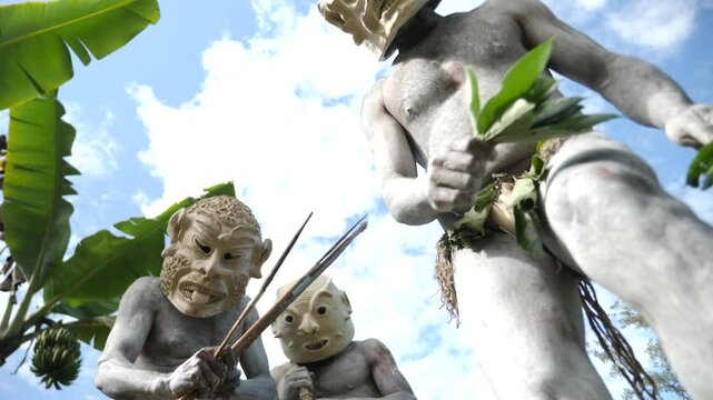 Asaro Mudmen tribe bow hunting. Papuan tribe dance. Mount Hagen tribe festival. Cultural event. Indigenous men in native costumes. High quality 4k footage
