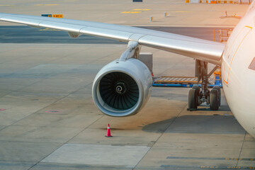 Airplane wing with engine and the chassis rack, view from above the plane during flight service